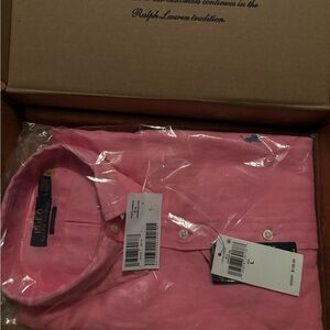 pink men’s polo. Never worn still in the plastic and original box it came in.